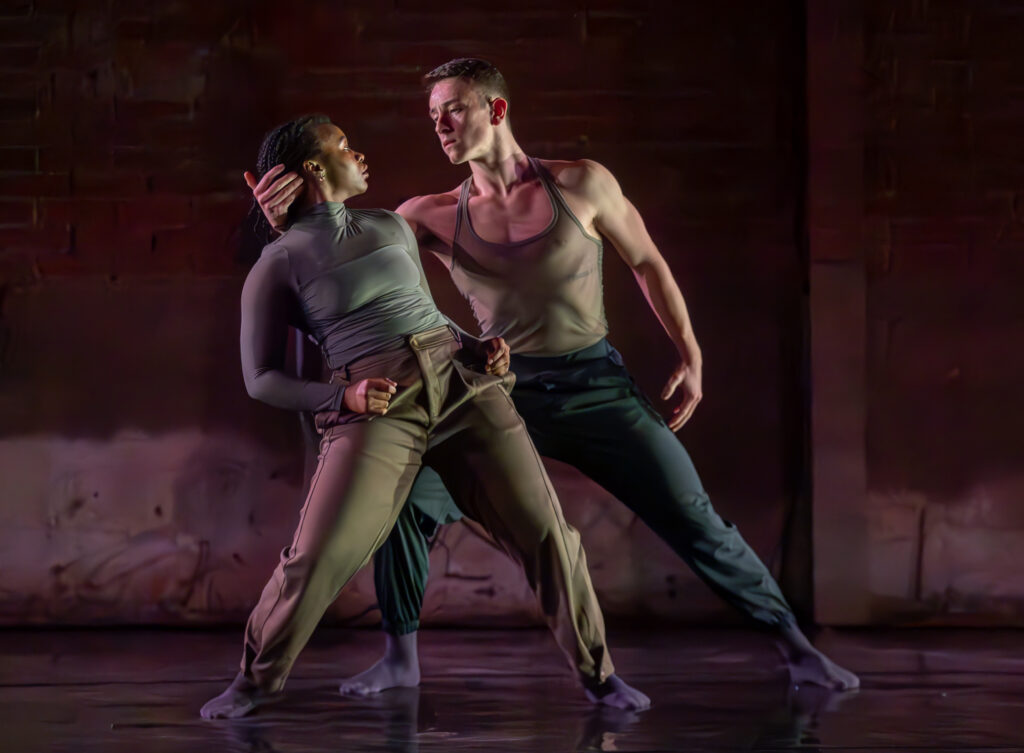 Two dancers in an embrace on stage